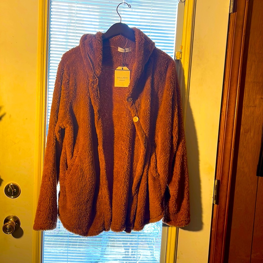 Lite weight jacket with hood. Rusted color. Buttons in front .